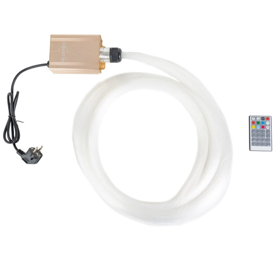 De Sterrenhemel RGB (900 sterren) met afstandsbediening heeft een goudkleurige LED-lichtbron met een netsnoer, bevestigd aan een opgerolde bundel witte glasvezelstrengen en een afstandsbediening die aan de rechterkant is geplaatst.